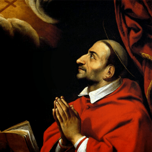 Imagem de São Carlos Borromeu com vestes eclesiásticas vermelha com a bíblia aberta e olhando para o céu
