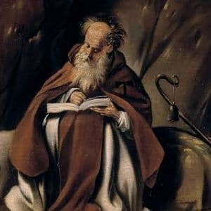 Imagem de Santo Antão escrevendo sentado a uma pedra... tem seu cajado ao lado